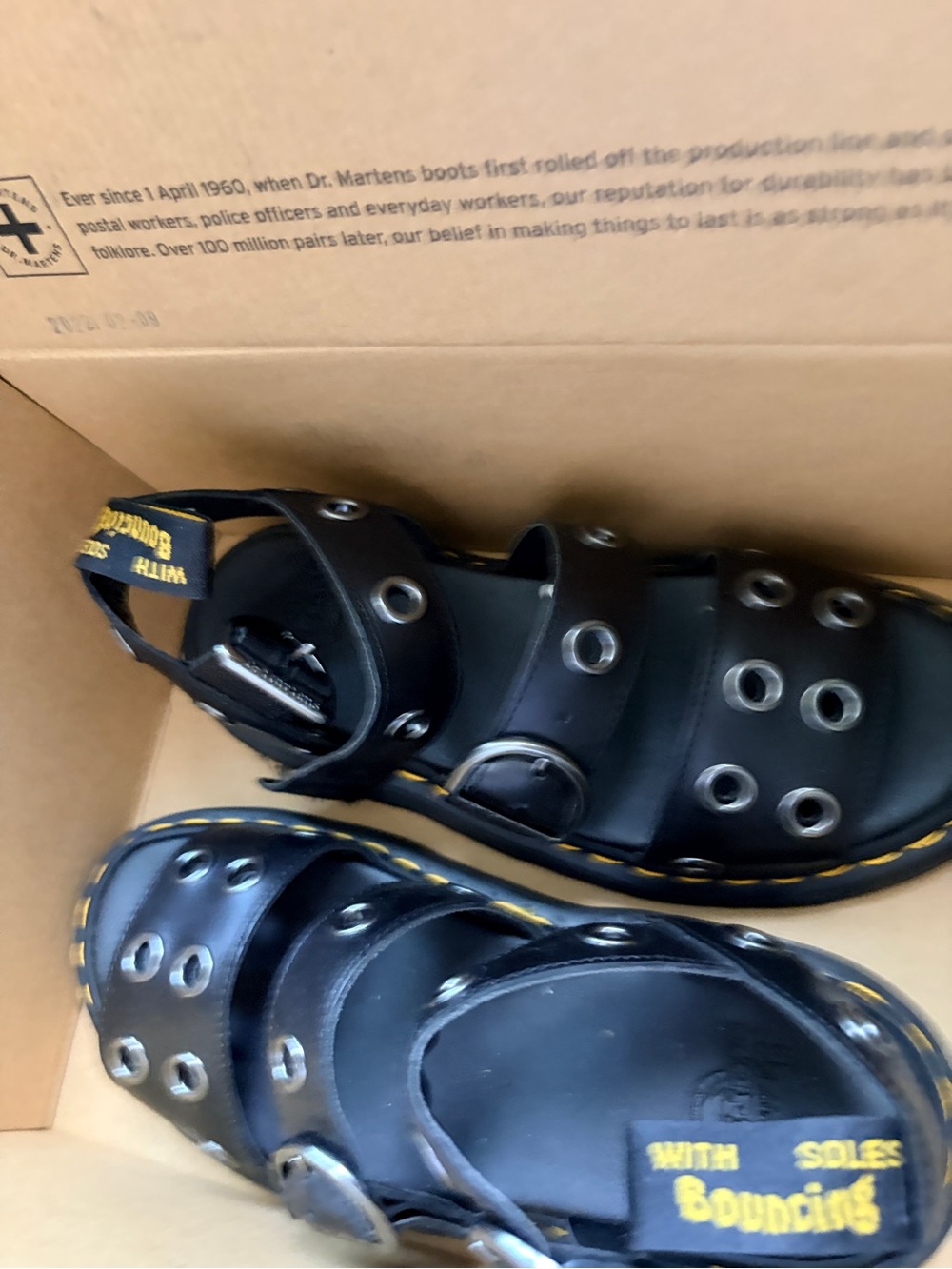 Dr. Martens Kids Black Leather Eyelet Strap Sandals with Yellow Stitching